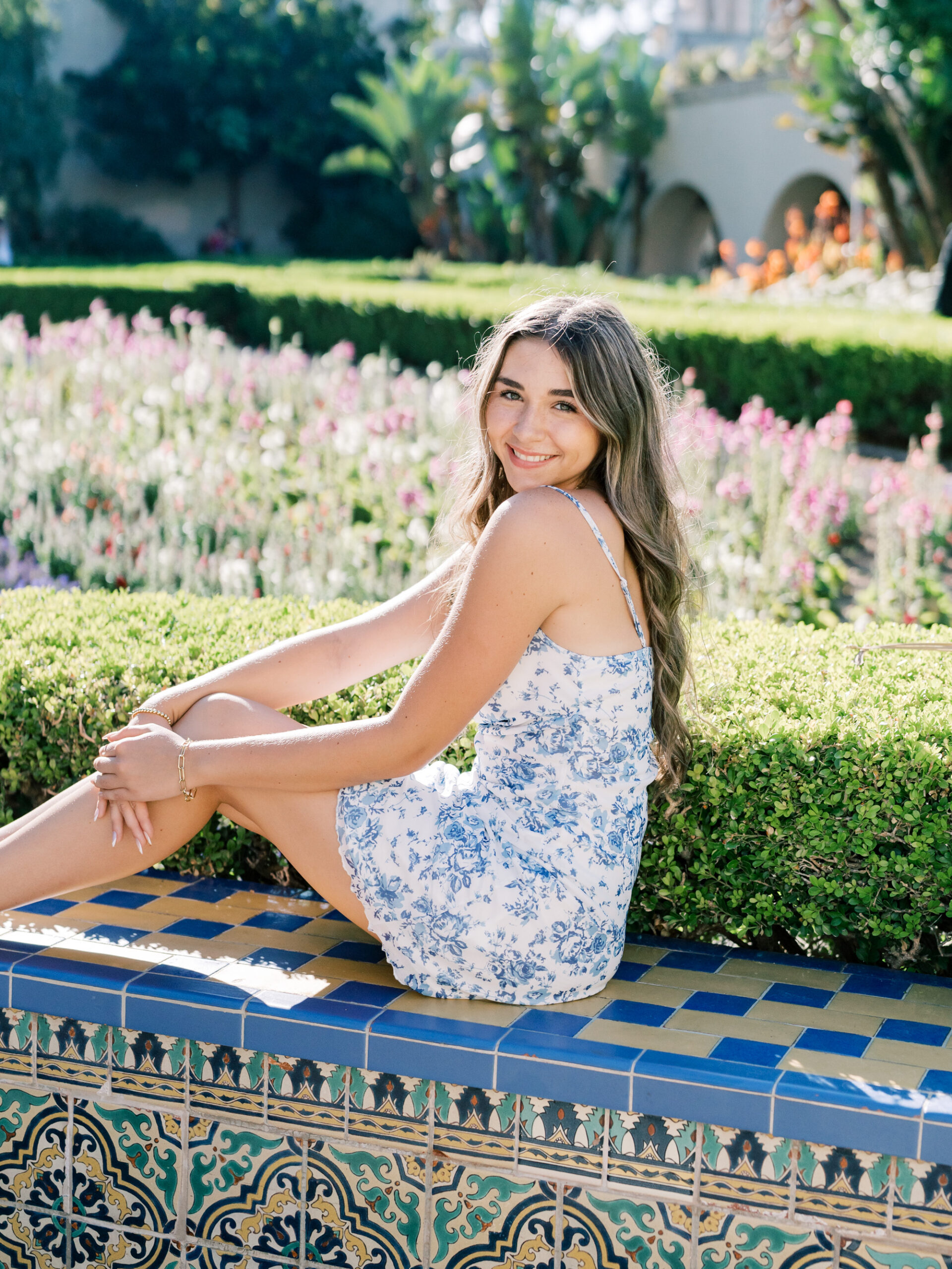 Senior Portraits at Balboa Park By Light & Airy Film Photographer, Mandy Ford | Spanish Tile Inspired Senior Pictures At Balboa Park Gardens Senior Picture Posing Inspiration For Girls Sitting